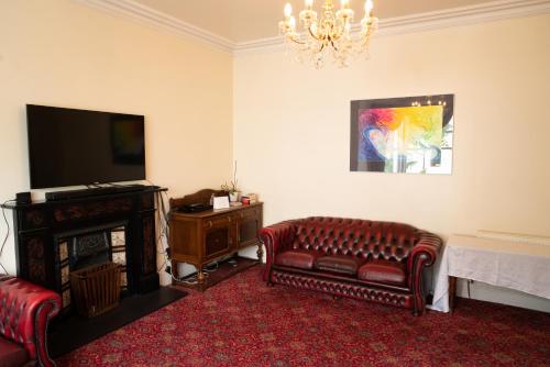 
a living room filled with furniture and a fire place at Llandudno Hostel in Llandudno
