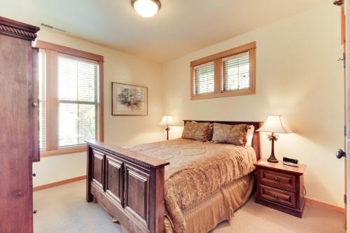 a bedroom with a bed and two windows at 29 Fremont Crossing in Sunriver