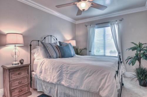 a bedroom with a bed and a ceiling fan at Monterey B in San Clemente
