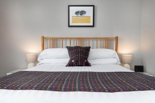 a bedroom with a bed with a pillow on it at Bodnant Guest House in Llandudno