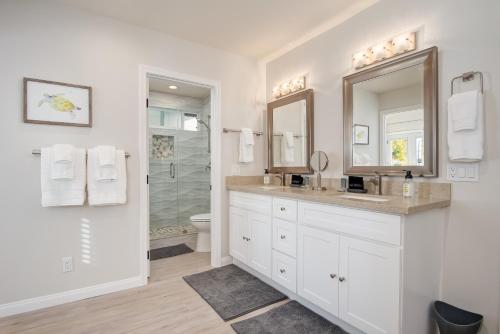 a white bathroom with a sink and a shower at Villa Del Mar in San Clemente