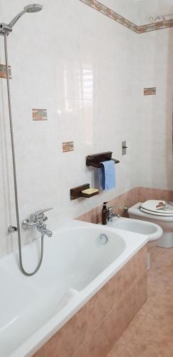 a bathroom with a bath tub and a toilet at Vacanze in Sicilia in Siculiana