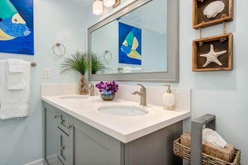 a bathroom with a sink and a mirror at Hideaway Unit C in San Clemente