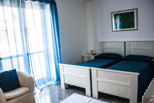 a bedroom with a bed and a chair and a window at Andreina a San Pietro Apartment in Rome