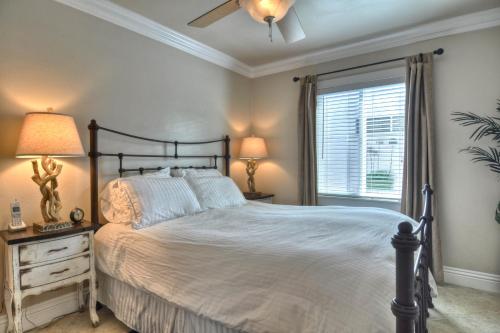 a bedroom with a large bed and a window at Monterey C in San Clemente