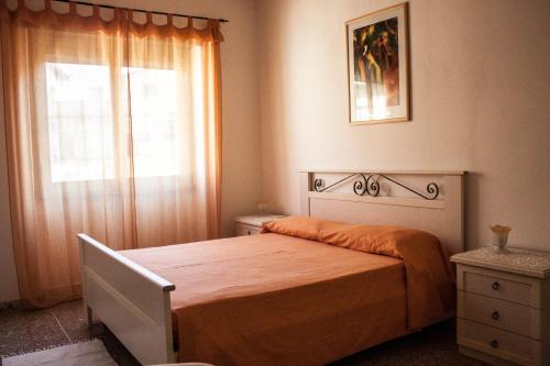 a bedroom with a bed with an orange blanket and a window at Andreina a San Pietro Apartment in Rome