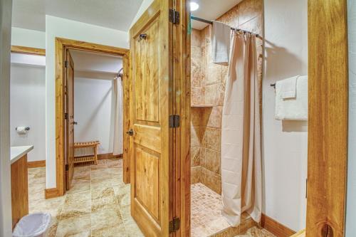 a bathroom with a shower and a wooden door at Moab Rim View in Moab
