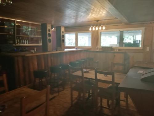 a restaurant with a bar and tables and chairs at Gasthof Schlossberg in Signau