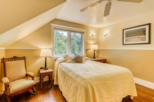 a bedroom with a bed and a window and a chair at 6 Bed 4 Bath Vacation home in Eastsound in Eastsound
