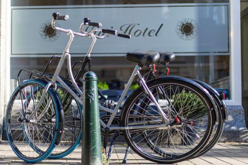 
two bicycles parked next to each other in front of a building at Sleep&Stay Floris IV in The Hague
