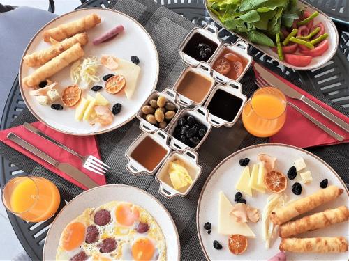 a table topped with plates of food and containers of food at Hotel Marina Bay Göcek in Göcek