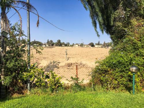 a field with a dirt field in the background at Rio desert view apartment in Arad