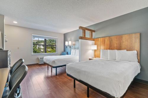 a hotel room with two beds and a window at Extended Stay America Premier Suites - Seattle - Bellevue - Downtown in Bellevue