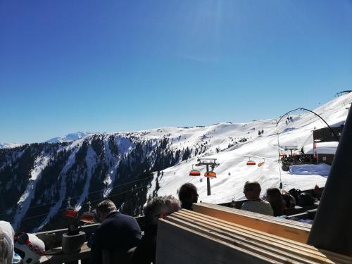 a group of people standing on a ski slope at Julia in Kaprun