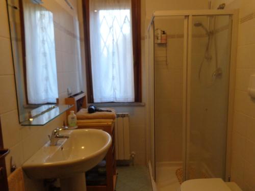 La salle de bains est pourvue d'un lavabo et d'une douche. dans l'établissement lidoapartment, à Fano