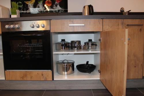 a kitchen with a stove and some pots and pans at Haus in der Kurve in Kappl