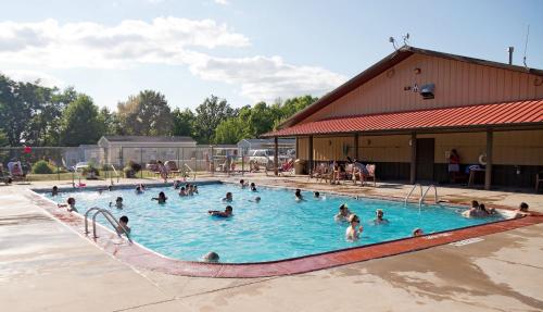 a group of people in a swimming pool at O'Connell's RV Campground Deluxe Park Model 38 in Inlet