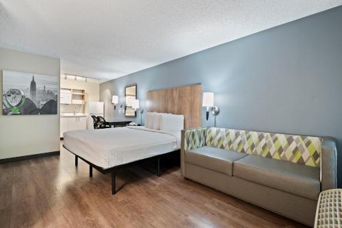 a hotel room with a bed and a couch at Extended Stay America Suites - Seattle - Redmond in Bellevue