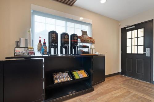 a room with a shelf with alcohol bottles on it at Extended Stay America Suites - Seattle - Redmond in Bellevue
