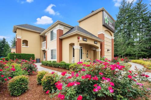 a building with pink flowers in front of it at Extended Stay America Suites - Seattle - Redmond in Bellevue