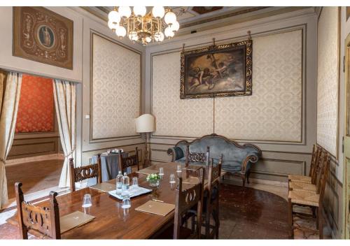 a living room filled with furniture and a table at PHI Hotel Canalgrande in Modena