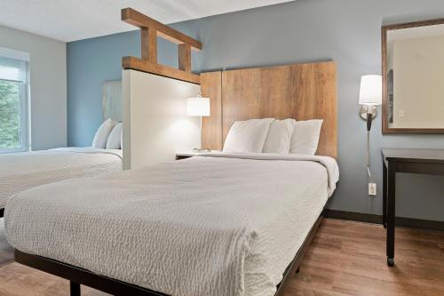 a hotel room with two beds and a fireplace at Extended Stay America Suites - Seattle - Redmond in Bellevue