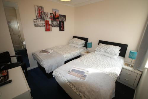 two beds in a small room with two at Red Lion in Swaffham