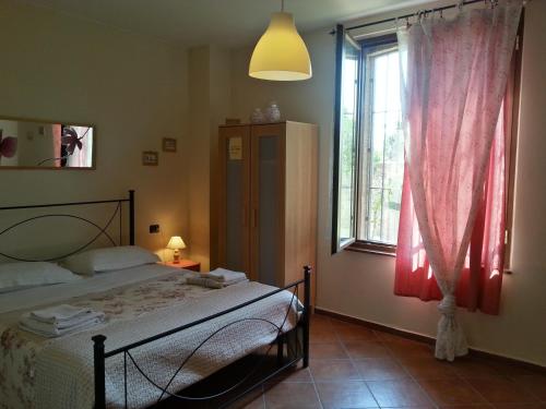 a bedroom with a bed and a large window at Agriturismo La Fattoria Del Boschetto in Fontanellato