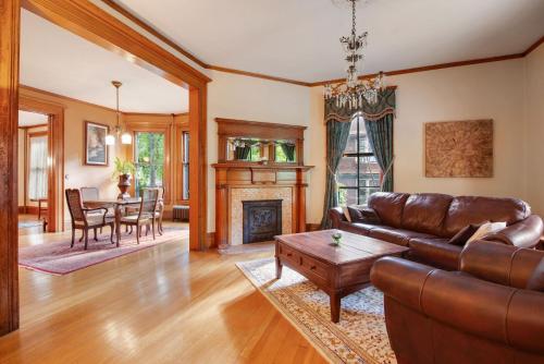 a living room with a leather couch and a table at Historic District BnB in Saint Paul