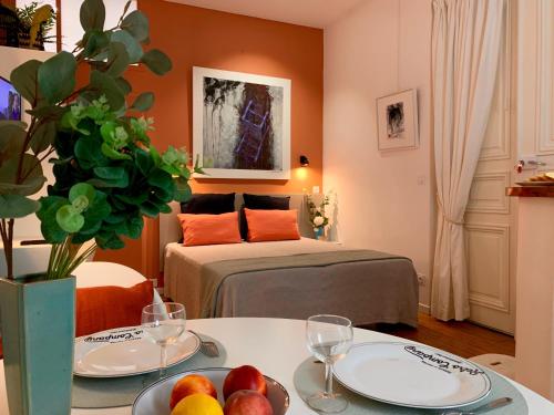 une chambre avec un lit et une table avec des fruits dessus dans l'établissement L'Art Studio hyper centre, à La Rochelle