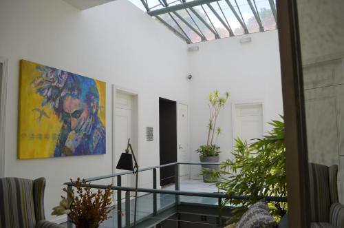 a hallway with a painting on the wall and a staircase at Hotel Villa Condesa in Mexico City