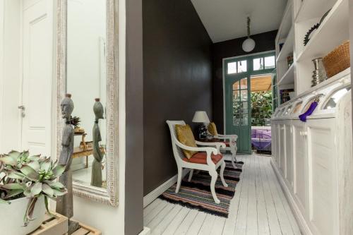 a living room with a mirror and a chair at Hotel Villa Condesa in Mexico City