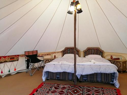 a bedroom with a canopy bed in a tent at Al Reem Desert Camp in Jalan Bani Buhassan