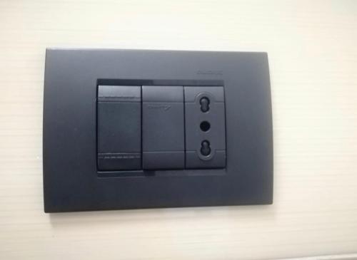 a black light switch on a wall at LA CONCHIGLIA A MARINA in Marina di Carrara