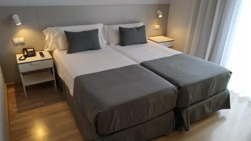 una habitación de hotel con una cama grande y una mesa en Mendez Nuñez Alicante, en Alicante