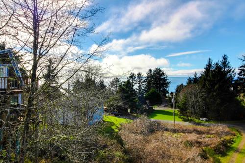 a view of a yard with trees and a house at Sitka Sky in Oceanside