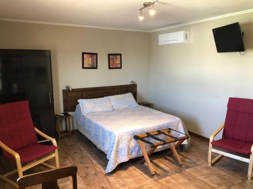 Un pat sau paturi într-o cameră la Loft & Suites Centro