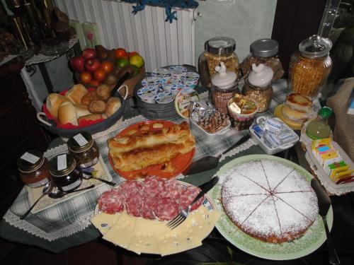 a table topped with lots of different types of food at The Queen Tower in Desenzano del Garda