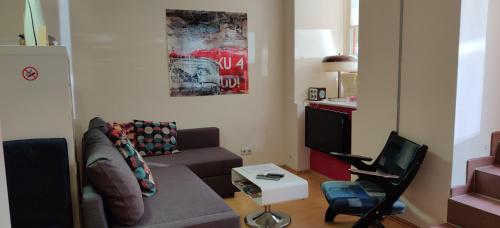 a living room with a couch and a tv at Appt Berlin in Berlin