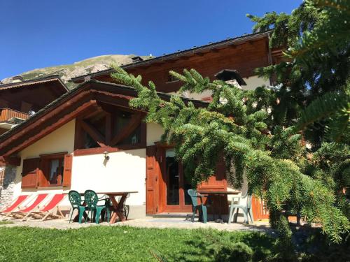 a house with a picnic table in front of it at Chalet Barbara in Livigno