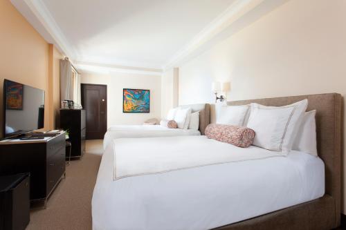 
A bed or beds in a room at Condado Vanderbilt Hotel

