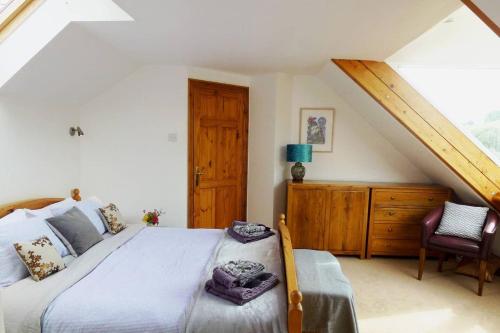 a bedroom with a large bed and a wooden cabinet at Writing Shed Wales in Login