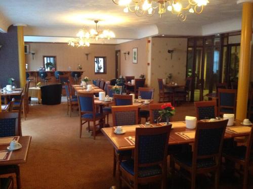 a dining room with wooden tables and chairs at SuyderSee Hotel in Enkhuizen