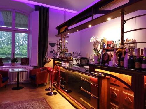 a bar with purple lighting in a room at Ravila Manor in Kose