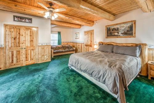 a bedroom with a bed and green carpet at Vienna Villa - 3 Bed 3 Bath Vacation home in Shaver Lake in Shaver Lake