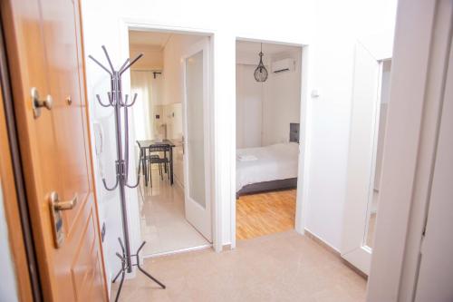 a hallway with a room with a bed and a mirror at Thessaloniki Center Apartment On The Sea in Thessaloniki