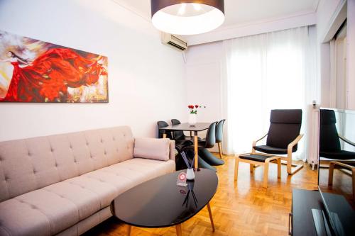 a living room with a couch and a table at Thessaloniki Center Apartment On The Sea in Thessaloniki
