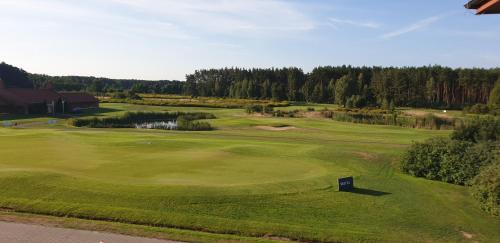 an overhead view of a golf course with a green at ApartGolf Sobienie Królewskie in Sobienie Szlacheckie