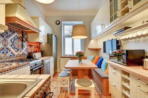 a kitchen with a table and a couch in it at Sopot Centrum Apartments in Sopot