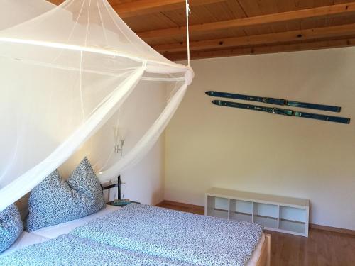 a bedroom with a bed with a mosquito net at Ferienwohnung Bärfeld in Fieberbrunn